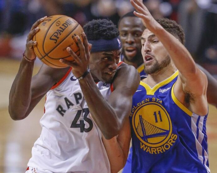 Draymond Green holding a basketball: Raptors forward Pascal Siakam goes up against Warriors guard Klay Thompson. The Raptors defeated the Warriors 118-109.