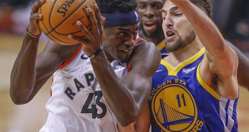 Draymond Green holding a basketball: Raptors forward Pascal Siakam goes up against Warriors guard Klay Thompson. The Raptors defeated the Warriors 118-109.