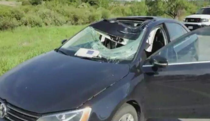 a car parked on the side of a vehicle: A car tire from a northbound vehicle went flying into a woman driving in the southbound lanes of Highway 400 north of Highway 89.