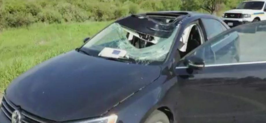 a car parked on the side of a vehicle: A car tire from a northbound vehicle went flying into a woman driving in the southbound lanes of Highway 400 north of Highway 89.