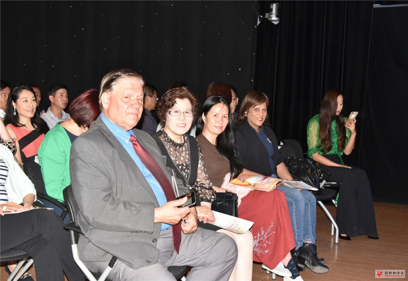 A group of people sitting posing for the camera Description automatically generated