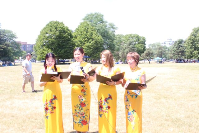 A group of women in yellow dresses Description automatically generated with medium confidence