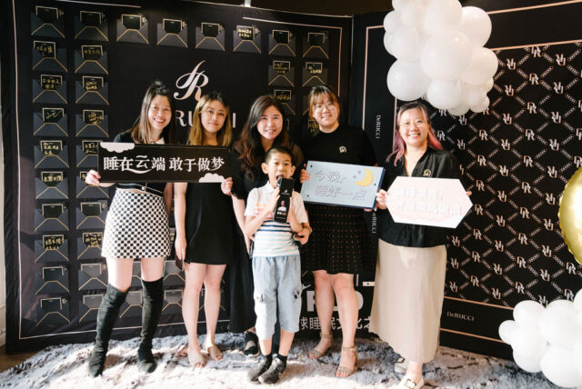 A group of women holding signs Description automatically generated with medium confidence