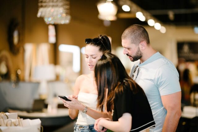 A person and person looking at a phone Description automatically generated with low confidence