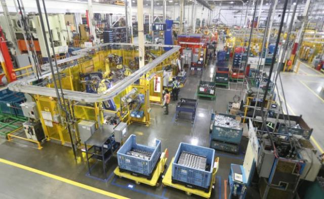 Workers on the floor of Alfield Industries, a subsidiary of Martinrea, one of three global auto parts makers in Canada, in Vaughan, Ontario, Canada April 28, 2017. Picture taken April 28, 2017. REUTERS/Fred Thornhill