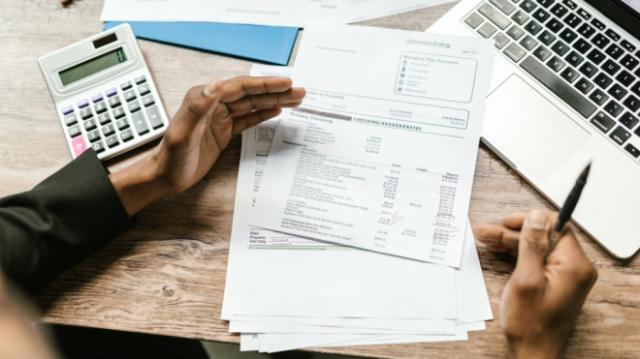 A man looks at his bills in this stock photo. (RODNAE Productions/Pexels)