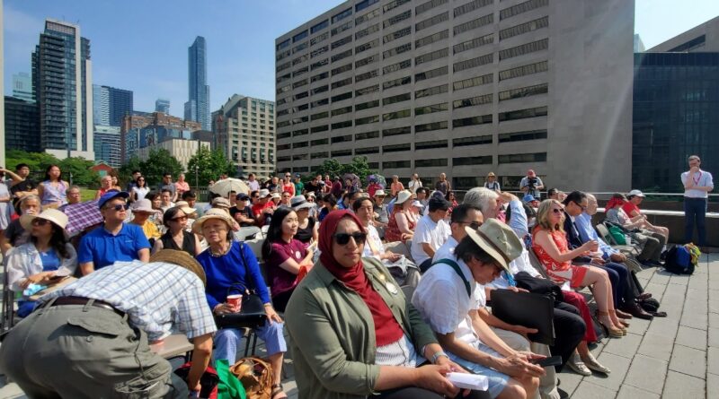 A group of people sitting on a bench Description automatically generated with low confidence