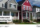 Grey, red, and white contemporary houses with young trees in the front yards sit side by side on a residential street. Text that reads: “Underused Housing Tax”.