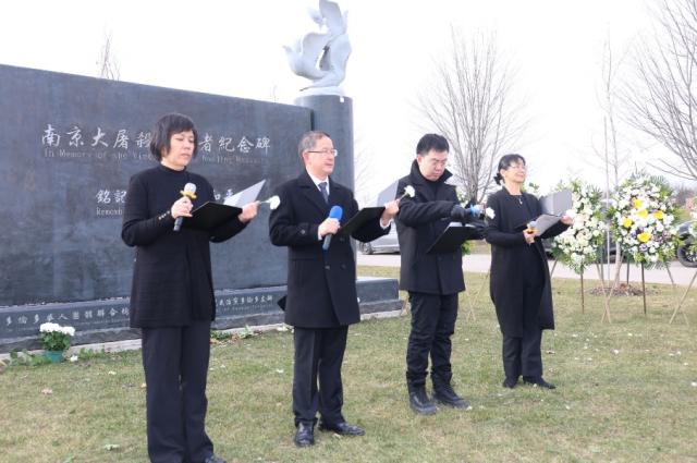 A group of people in black standing in a line holding microphones Description automatically generated