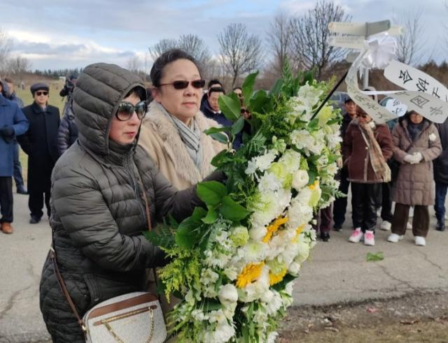 A group of people holding flowers Description automatically generated