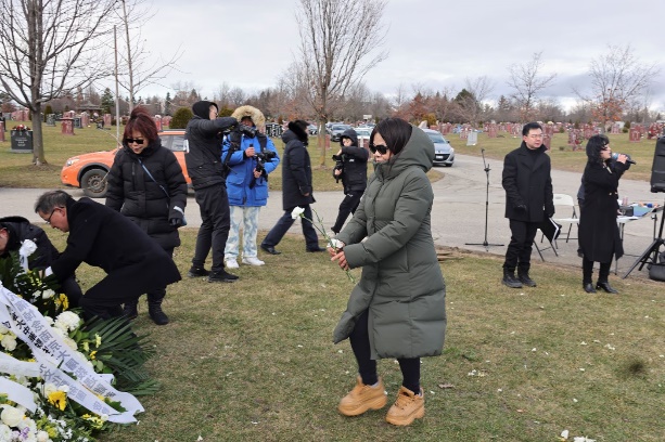 A group of people standing in a field Description automatically generated