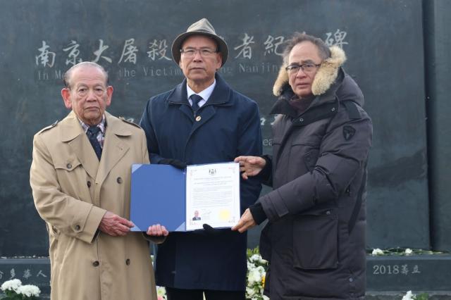 A group of men holding a piece of paper Description automatically generated