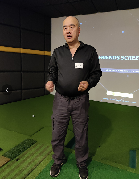 A person standing in front of a screen Description automatically generated