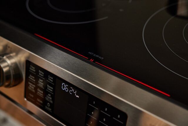 Close-up of a black and silver stove top AI-generated content may be incorrect.