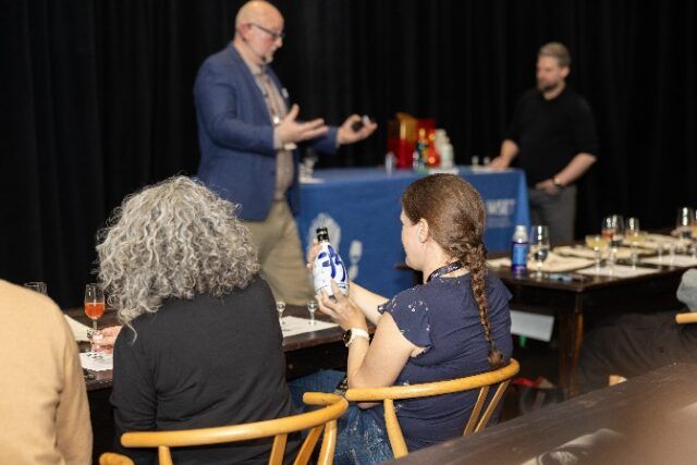 A group of people sitting at a table AI-generated content may be incorrect.