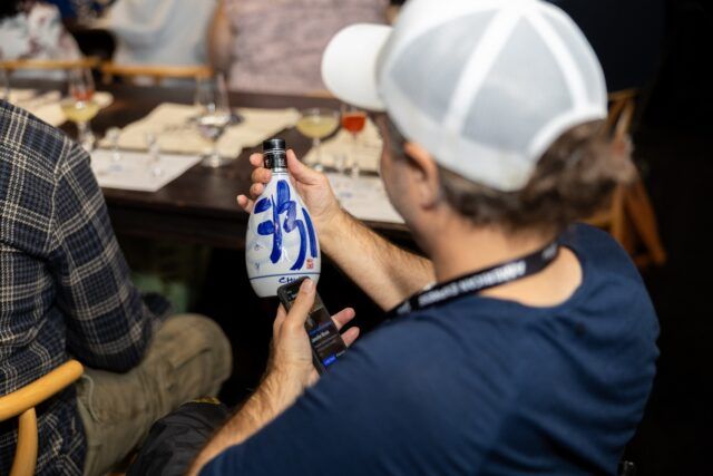 A person holding a bottle AI-generated content may be incorrect.