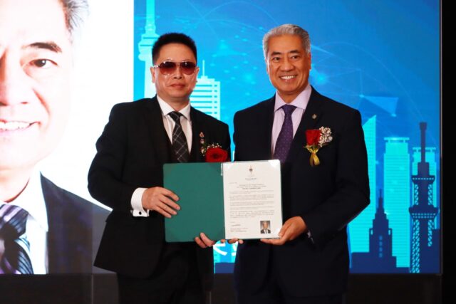 A couple of men holding a certificate AI-generated content may be incorrect.