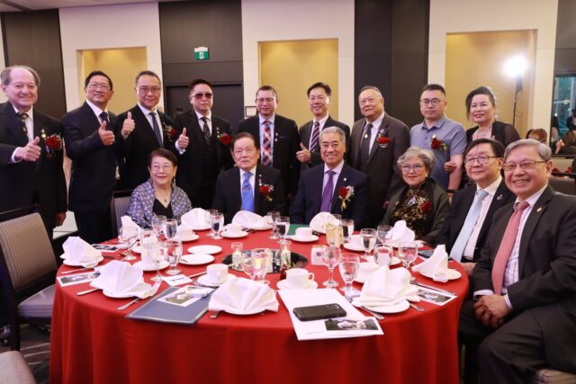 A group of people posing for a photo AI-generated content may be incorrect.