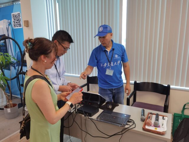 A group of people standing around a table

AI-generated content may be incorrect.