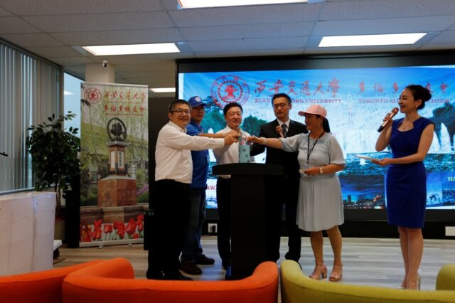 A group of people standing at a podium

AI-generated content may be incorrect.