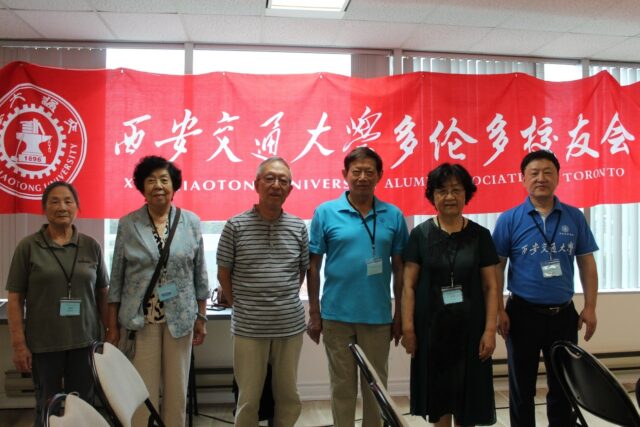 A group of people standing in front of a banner

AI-generated content may be incorrect.