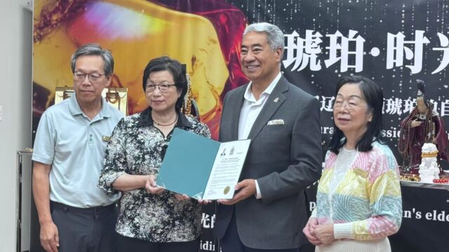 A group of people holding a certificate AI-generated content may be incorrect.