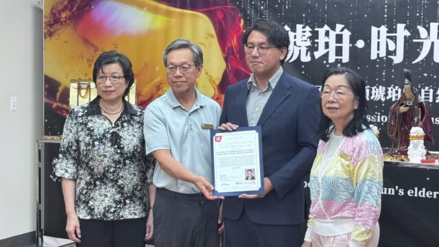 A group of people holding a paper AI-generated content may be incorrect.