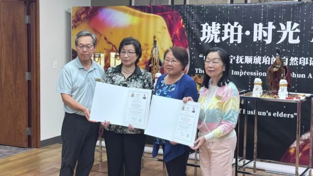 A group of people holding up a book AI-generated content may be incorrect.