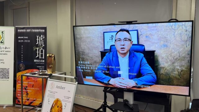 A person in a blue suit sitting on a desk AI-generated content may be incorrect.