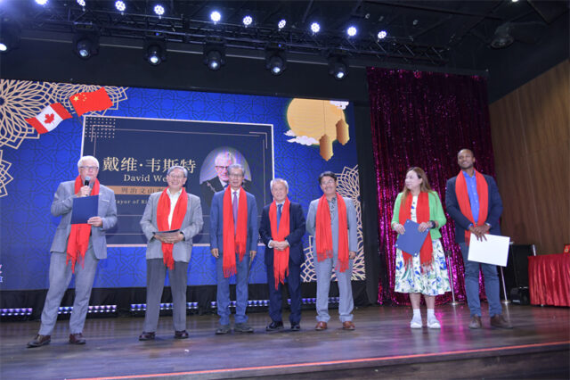 A group of people standing on a stage AI-generated content may be incorrect.