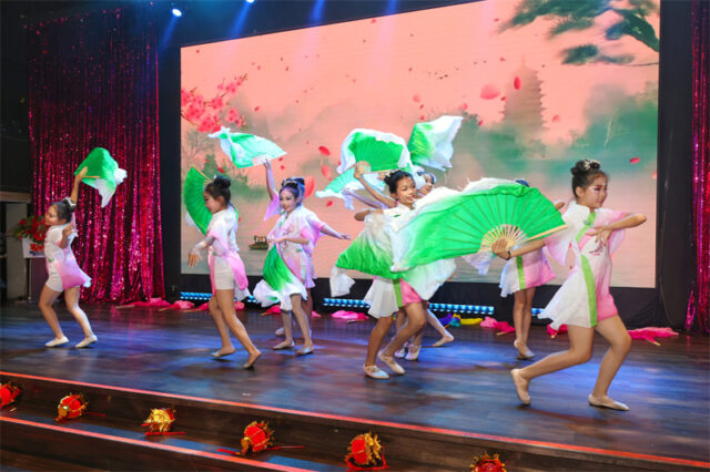 A group of women dancing on stage AI-generated content may be incorrect.