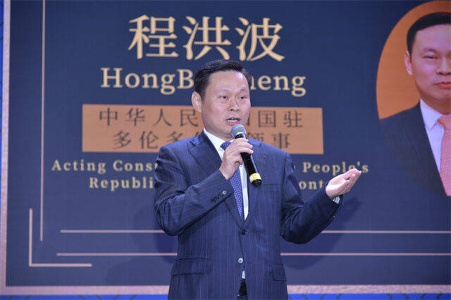 A person in a suit speaking into a microphone AI-generated content may be incorrect.