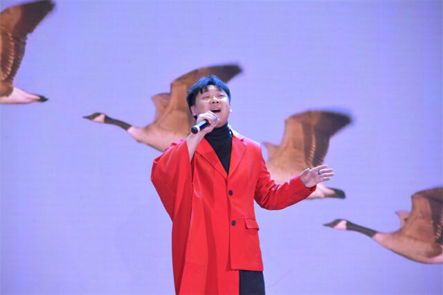 A person singing into a microphone AI-generated content may be incorrect.