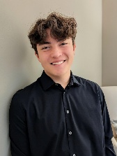 A person smiling at the camera AI-generated content may be incorrect.