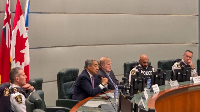 A group of men sitting at a table AI-generated content may be incorrect.