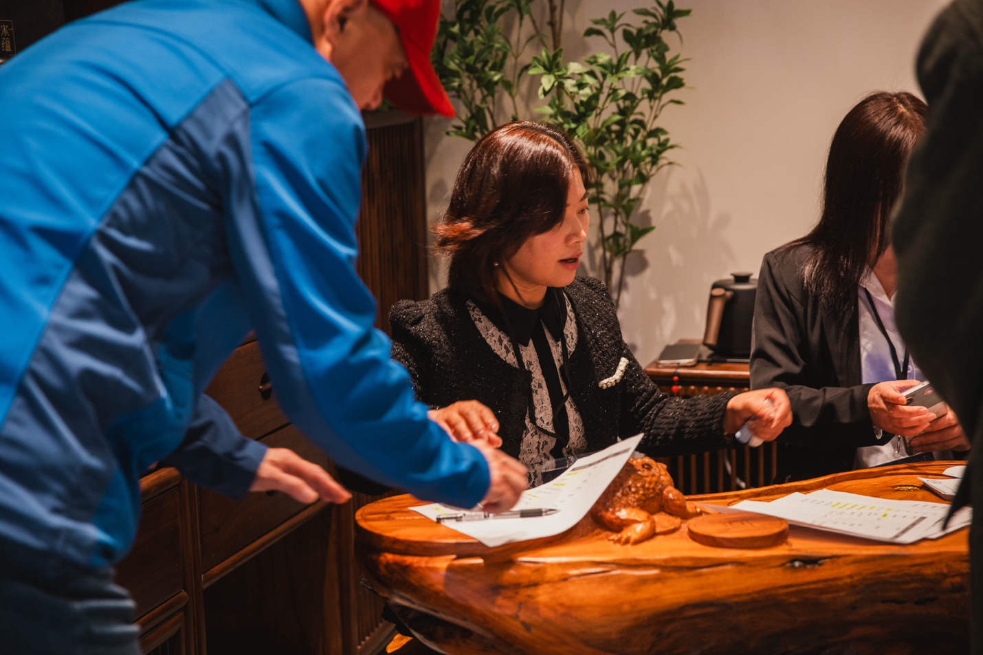 A group of people sitting at a table AI-generated content may be incorrect.